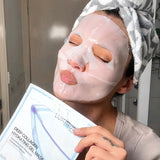 Person wearing a face mask and holding a product package in a bathroom setting