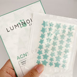 Packaging of Luminous Acne Hydrocolloid Tea Tree Strips with star-shaped stickers.
