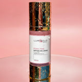 Luminous Empire Pink Peptide Eye Cream bottle on a pink background