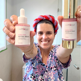 Woman holding two Luminous skincare products in a bathroom setting