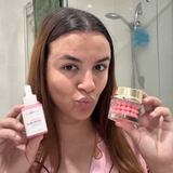 Woman holding Luminous Empire PDRN Serum and PDRN Capsule creams in a bathroom setting