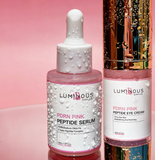 Two skincare bottles, a serum and a cream, from Luminous Empire on a pink background.
