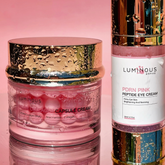 Collagen Capsule cream and PDRN Peptide eye cream with 'Luminous Empire' branding on a pink background.
