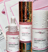 Luminous Empire skincare products including serum, eye cream, and collagen cream and 4 masks on a pink background.