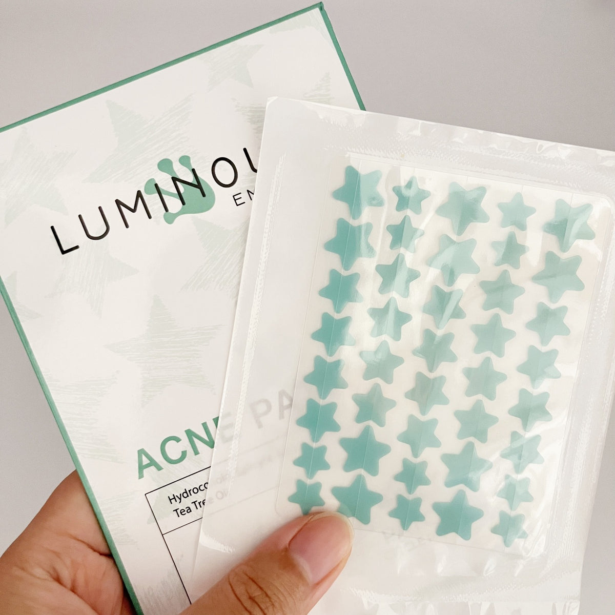 Packaging of Luminous Acne Hydrocolloid Tea Tree Strips with star-shaped stickers.