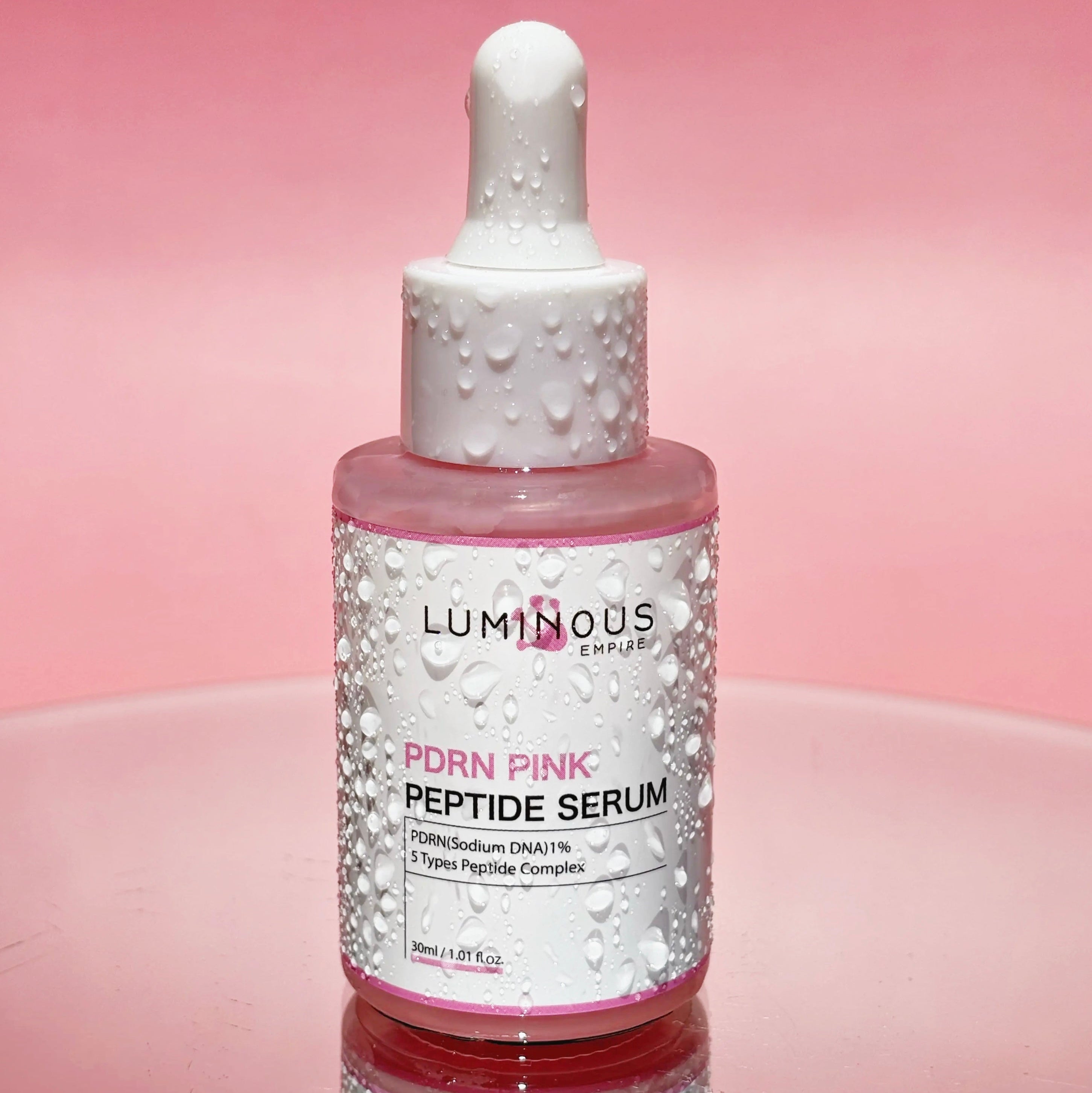 Luminous Pdrn Pink Peptide Serum bottle on a pink background
