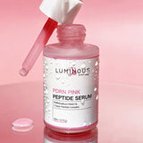 Luminous Peptide Serum bottle with dropper on a pink background